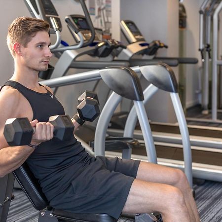 Meriton Suites North Ryde Sydney Exteriör bild A man using a dumbbell to exercise
