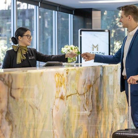 Meriton Suites North Ryde Sydney Exteriör bild A hotel receptionist