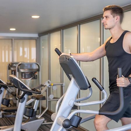 Meriton Suites North Ryde Sydney Exteriör bild A man using an elliptical trainer